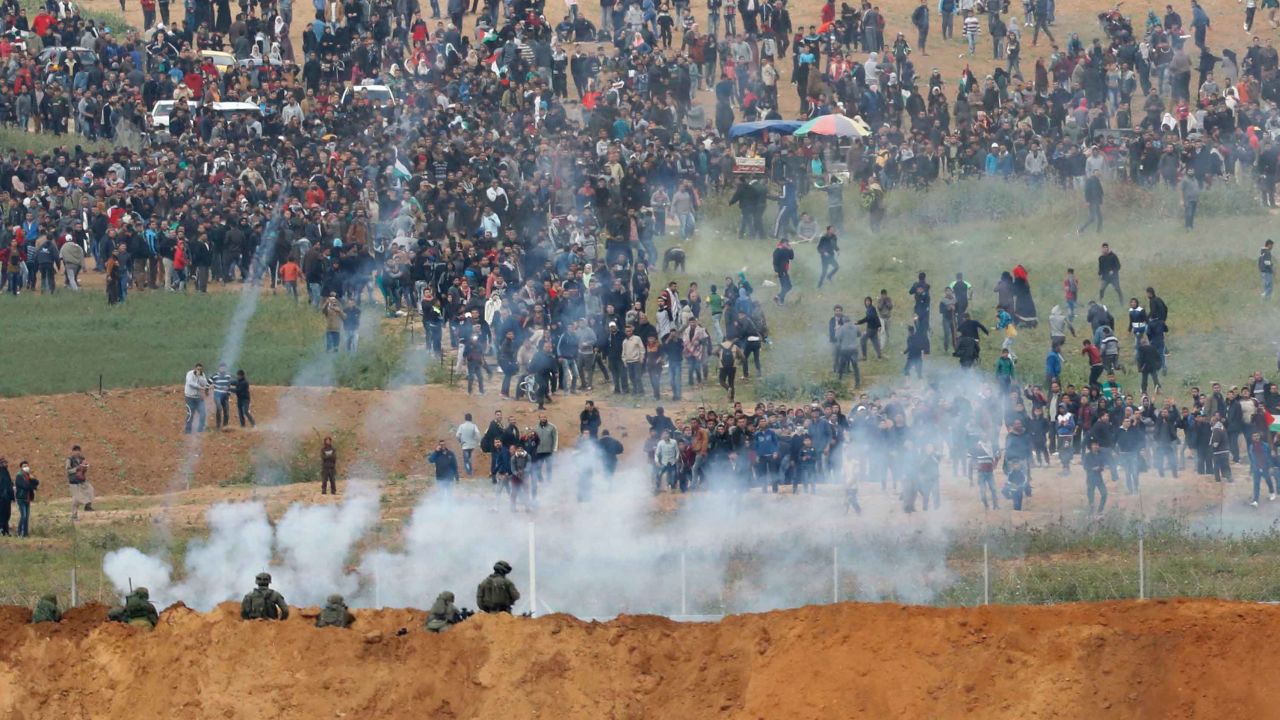 Israeli forces fire tear gas toward Palestinian protesters at the Gaza border fence Friday.