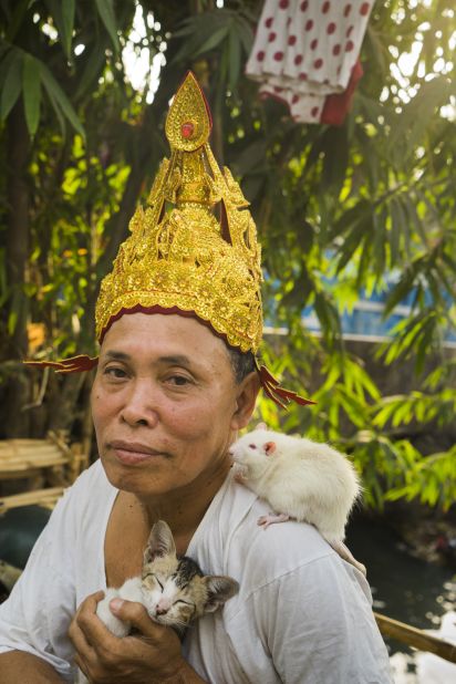 A Mandalay spirit medium, U Lin Lin, poses for a photo in a ceremonial headdress.