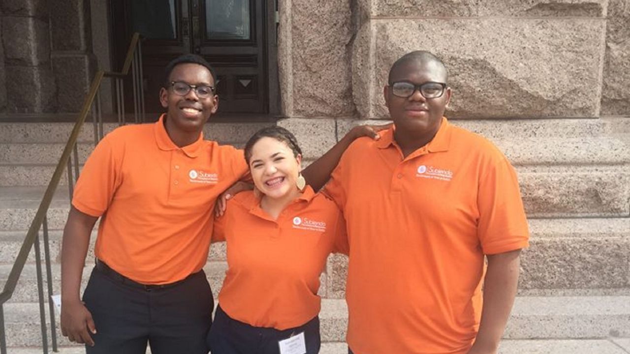 Micheal, far right, stands with friends Eric Muthondu and Sammantha Garcia during the Subiendo Academy at University of Texas Austin. All three are first-generation college students that have been accepted to Harvard. 