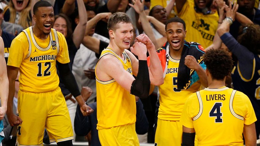 Michigan's Moritz Wagner, second from left, celebrates with his teammates during the second half in the semifinals of the Final Four NCAA college basketball tournament against Loyola-Chicago, Saturday, March 31, 2018, in San Antonio. (AP Photo/Brynn Anderson)