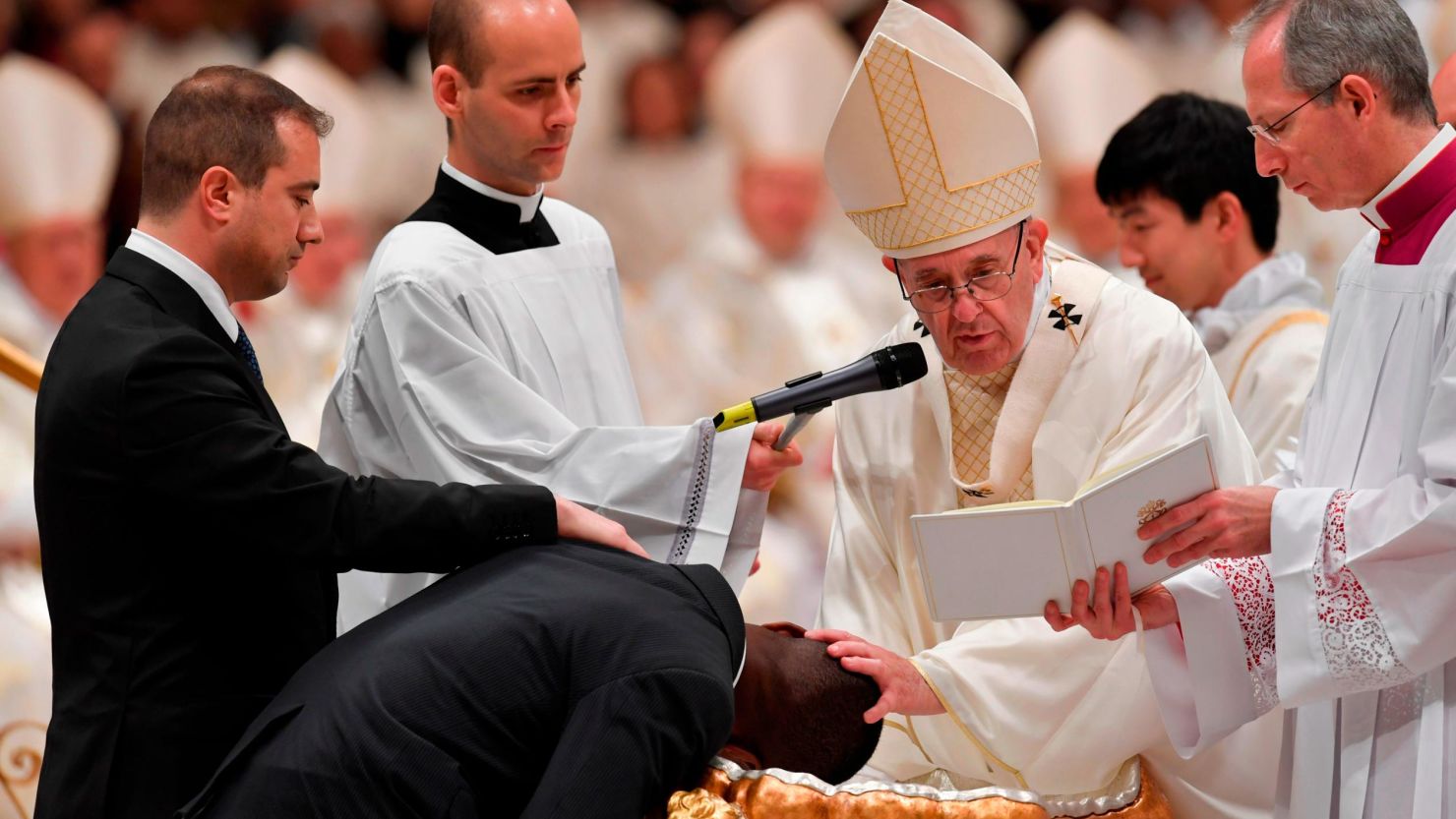 Pope Francis baptizes migrant John Ogah during Saturday's Easter service at the Vatican. 