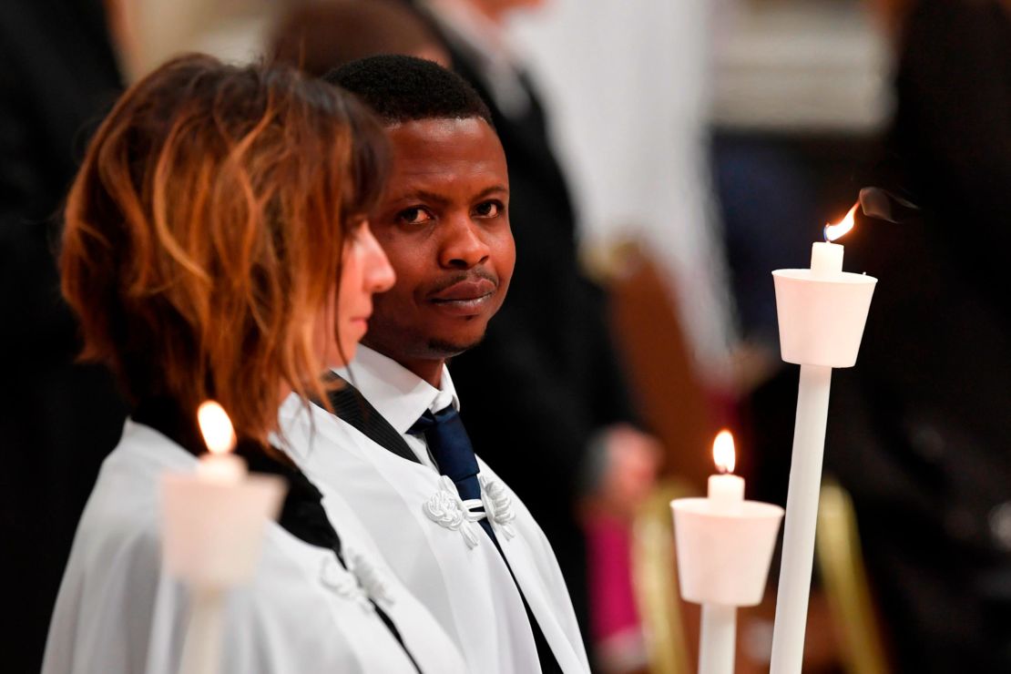 Migrant John Ogah looks on after being baptized by Pope Francis during the Easter Vigil at St. Peter's Basilica.