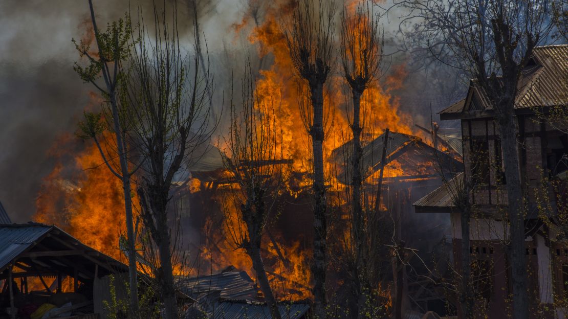 Homes where militants took refuge during a gun battle with Indian armed forces are engulfed in flames on April 1, 2018, in Indian-administered Kashmir.