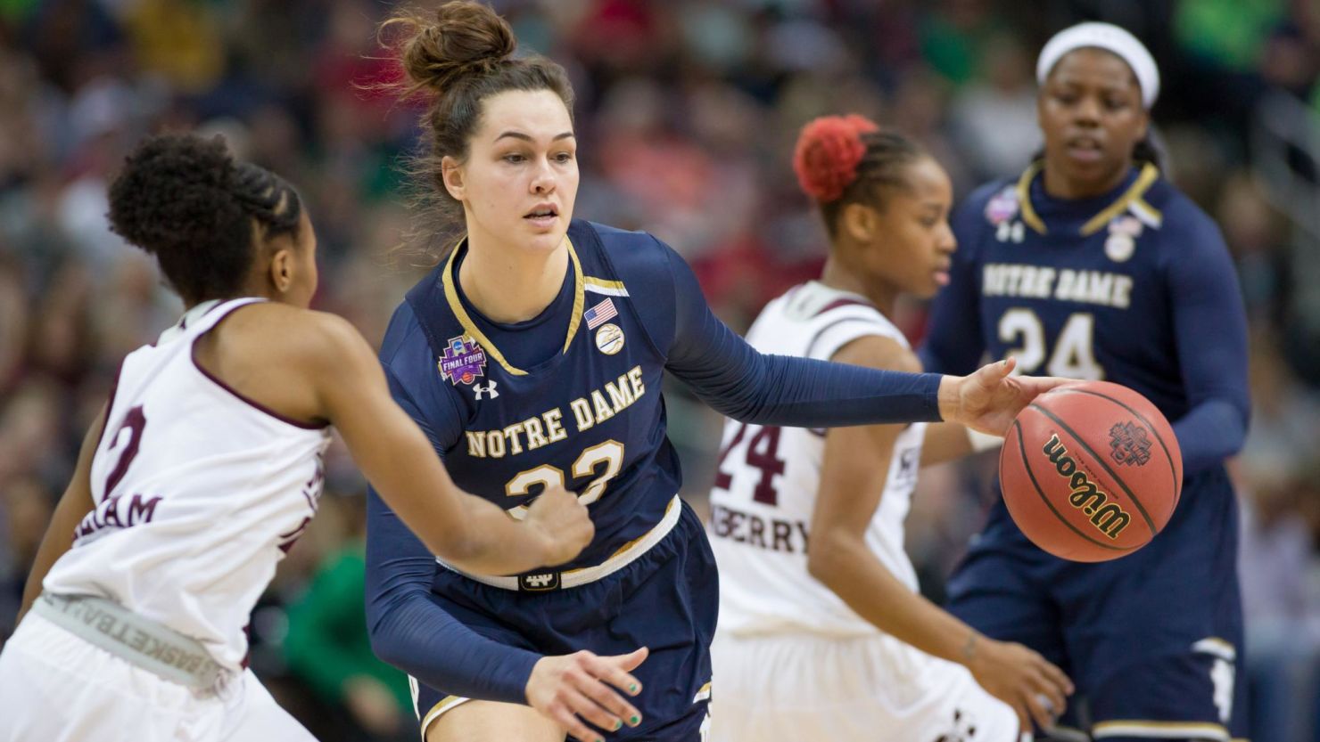 Notre Dame Fighting Irish forward Kathryn Westbeld (33) drives past Mississippi State Lady Bulldogs guard Morgan William (2) in the National Championship game.