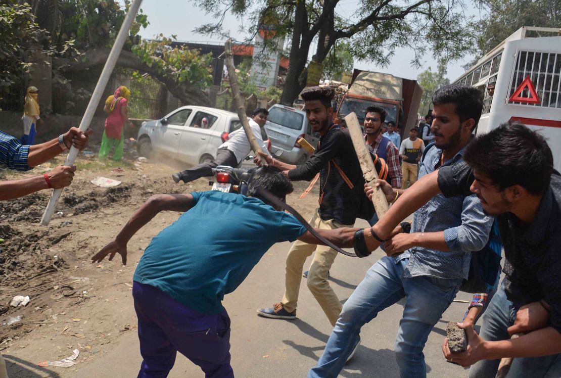 A protester is beaten by Indian students after members of the Dalit community and other "low caste" groups threw bricks at their college during countrywide protests on April 2, 2018 in Meerut in Uttar Pradesh state, India. The protesters opposed a Supreme Court order they felt diluted the rights of members of the lower castes.