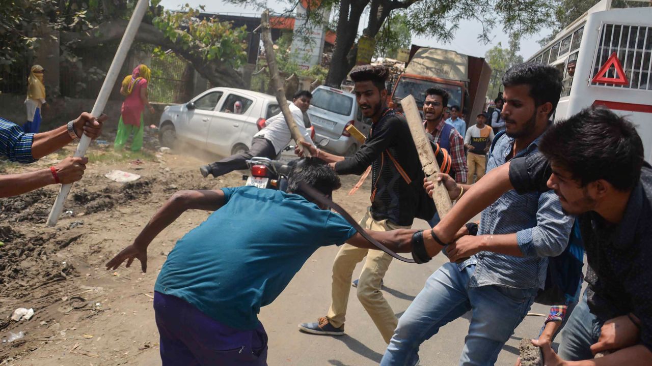 A protester is beaten by Indian students after members of the Dalit community and other "low caste" groups threw bricks at their college during countrywide protests on April 2, 2018 in Meerut in Uttar Pradesh state, India. The protesters opposed a Supreme Court order they felt diluted the rights of members of the lower castes. 