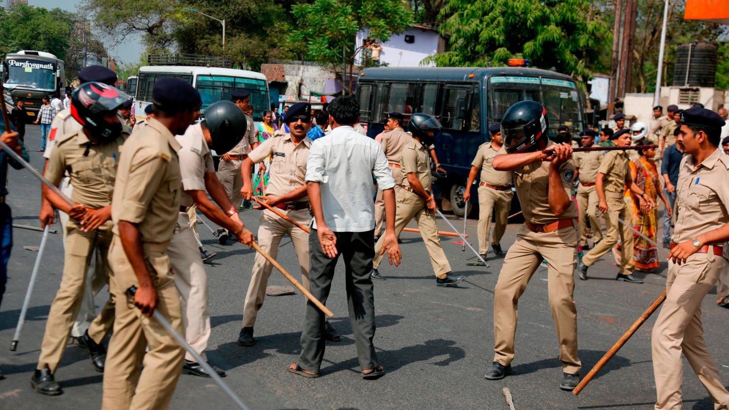 Police beat a protester in Ahmadabad during demonstrations Monday.