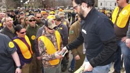 Rob Curtis hands out 30-round magazines at a protest outside the Vermont statehouse. 