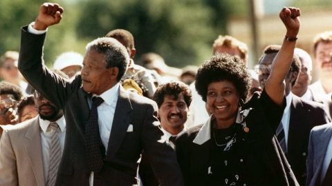Nelson and Winnie Mandela raise clenched fists to supporters upon Nelson's release from jail in February 1990. 