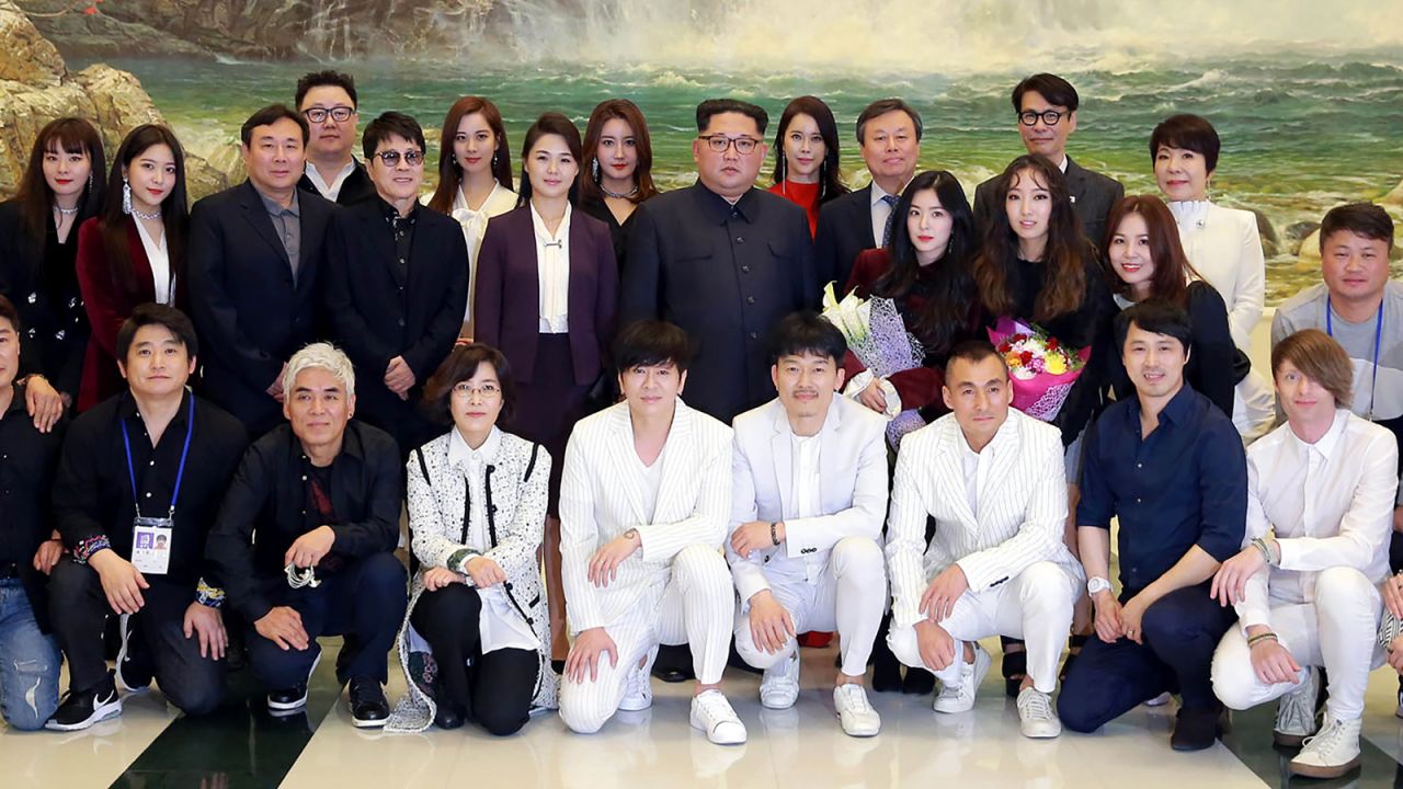 Ri and Kim pose for a photo on April 1, 2018 alongside South Korea's Culture, Sports and Tourism Minister Do Jong-whan (third line, third from right) and South Korean musicians after a rare concert by South Korean musicians at the 1,500-seat East Pyongyang Grand Theater in Pyongyang.