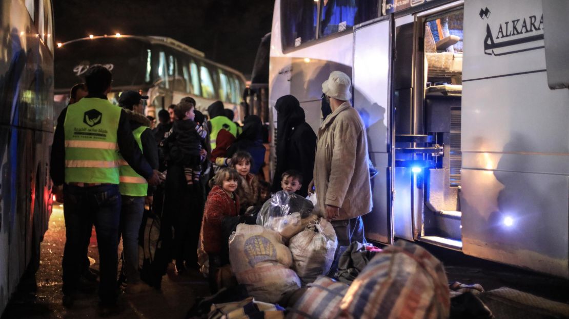 Syrian civilians and fighters are seen on Monday following their evacuation from Douma in Eastern Ghouta.