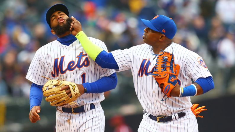 New York Mets teammates Amed Rosario, left, and Yoenis Cespedes joke around during their Opening Day game against St. Louis on Thursday, March 29.