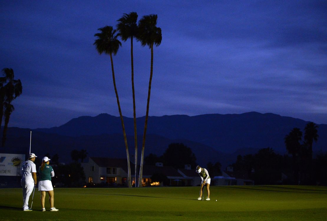 Pernilla Lindberg putts during Sunday's playoff as darkness falls.