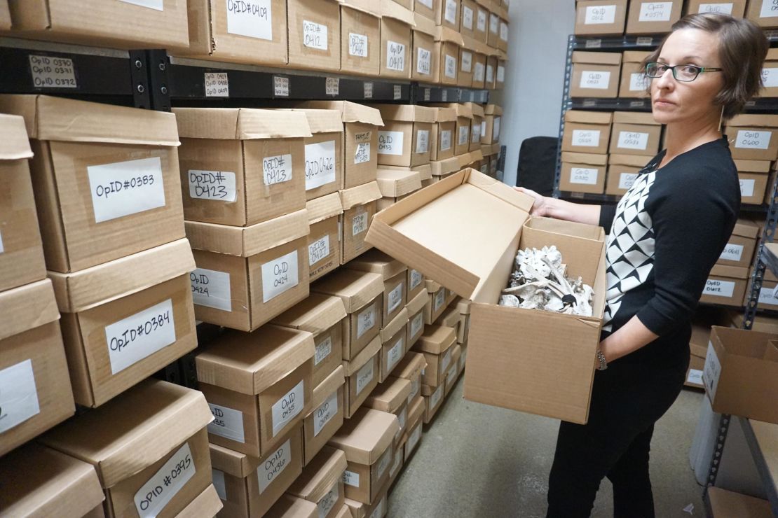 Kate Spradley, a forensic anthropologist in her lab at Texas State University, is trying to identify hundreds of bodies. Each box holds the remains of one person who died migrating to the United States.