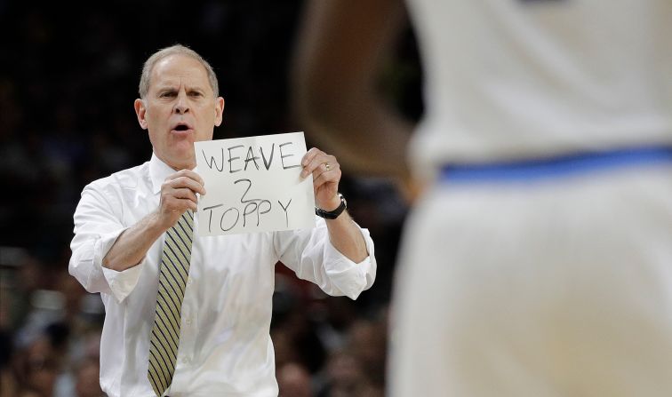Michigan's John Beilein uses visual aids to coach his team in the first half.