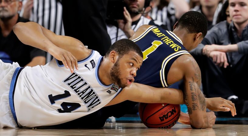 Villanova forward Omari Spellman, left, battles for a loose ball with Michigan's Charles Matthews during the second half. The game was played at the Alamodome in San Antonio.