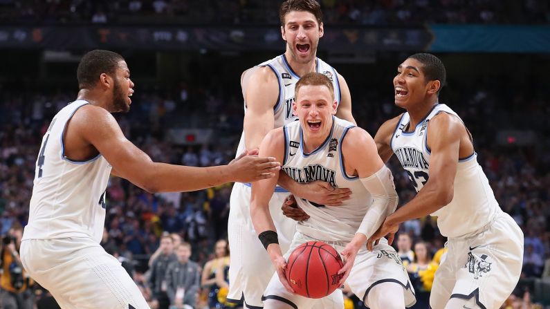 Donte DiVincenzo is mobbed by his Villanova teammates at the end of the national championship game on Monday, April 2. DiVincenzo came off the bench to score a game-high 31 points as the Wildcats blew out Michigan 79-62. It is their second title in three years.