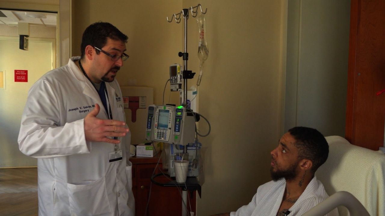 Dr. Joseph Sakran checks in with a patient.