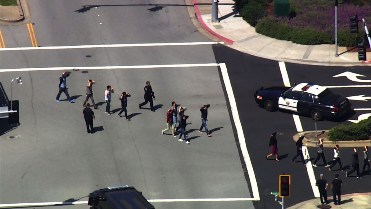 Overhead video from CNN affiliate KGO showed a heavy police presence. People gathered outside, and one by one they were were frisked and patted down by officers. Several roadways near the building were closed to traffic.