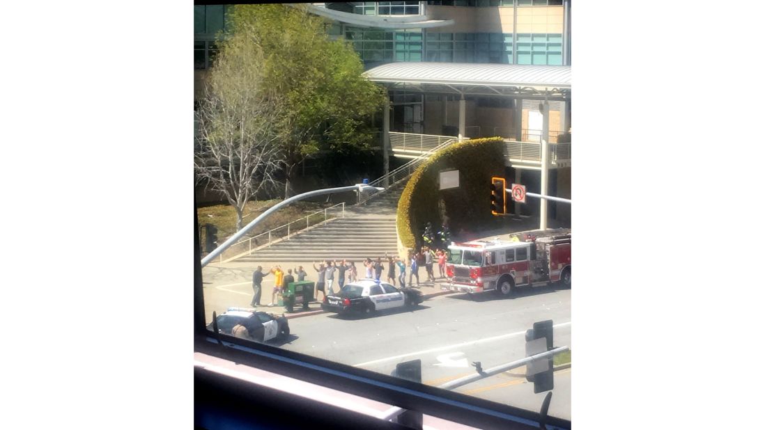 People gather outside the building. One YouTube employee said people were trying to get out of the building "as fast as they could."