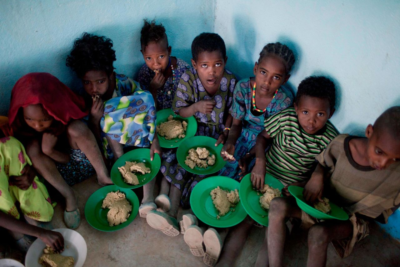 Children receive a hot meal provided by the humanitarian organization World Food Programme at a rural school in the city of Adama, also called Nazret or Nazareth, in central Ethiopia. Many of the students walk for an hour or two to school every morning, and in some cases, they attend school because of the free meals.