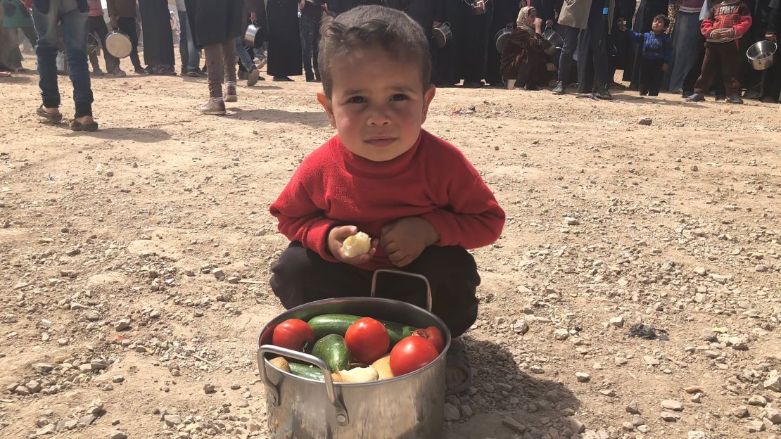 A boy from Eastern Ghouta shows his family's daily pot of food.