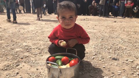 A boy from Eastern Ghouta shows his family's daily pot of food.