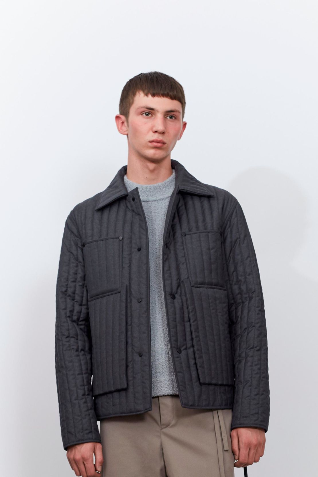 A grey quilted jacket from Craig Green's core collection.