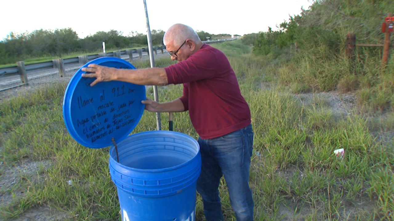 Eddie Canales, director of the South Texas Human Rights Center, checks a water station on a migrant route in Falfurrias, Texas.