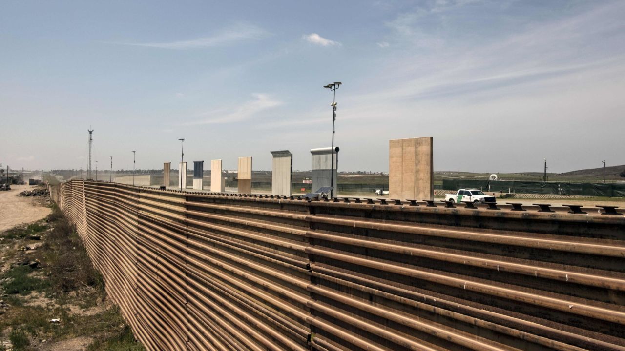 A US border patrol truck is seen next to US President Donald Trump's border wall prototypes from the US-Mexico border in Tijuana, northwestern Mexico, on April 3, 2018.
President Donald Trump on Tuesday vowed to deploy the military to secure America's southern border, as a caravan of Central American migrants heads north through Mexico toward the United States. / AFP PHOTO / GUILLERMO ARIAS        (Photo credit should read GUILLERMO ARIAS/AFP/Getty Images)