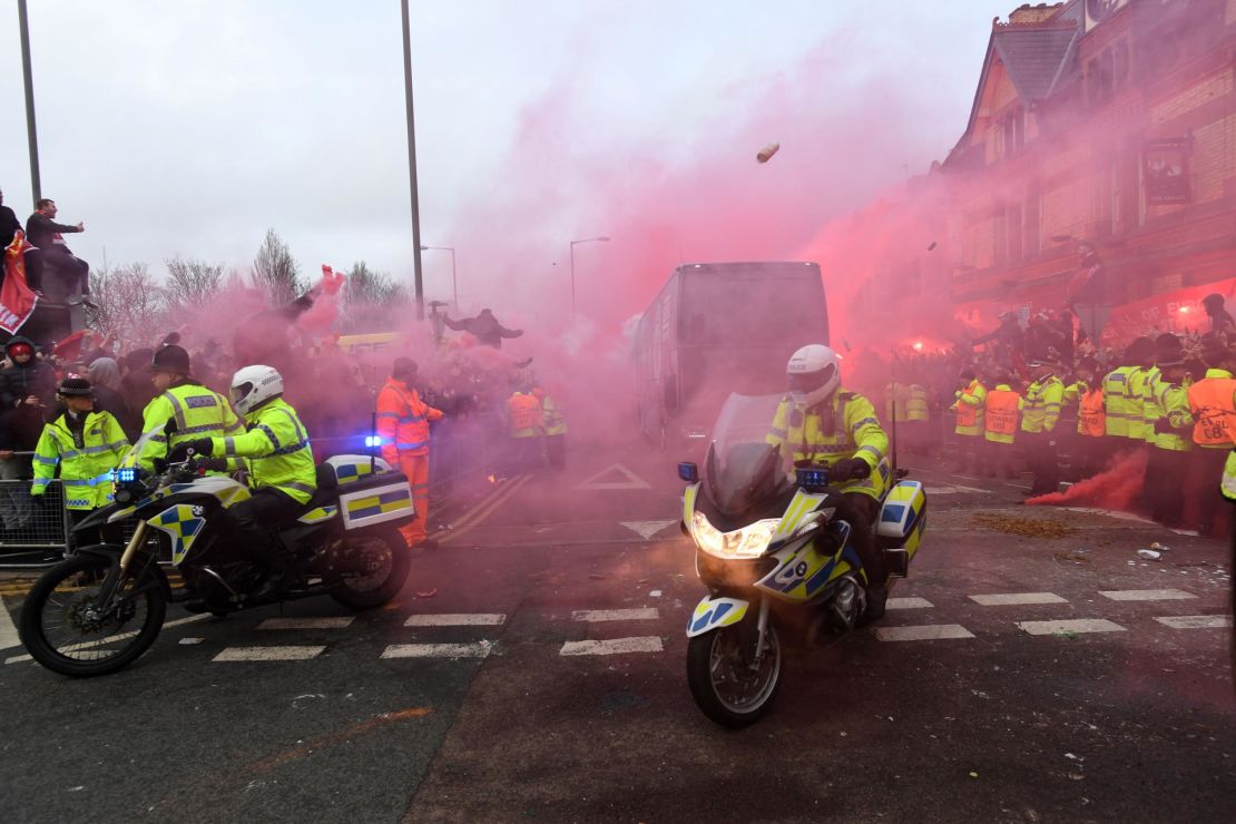 Manchester City's team bus is hit by projectiles thrown by Liverpool fans.