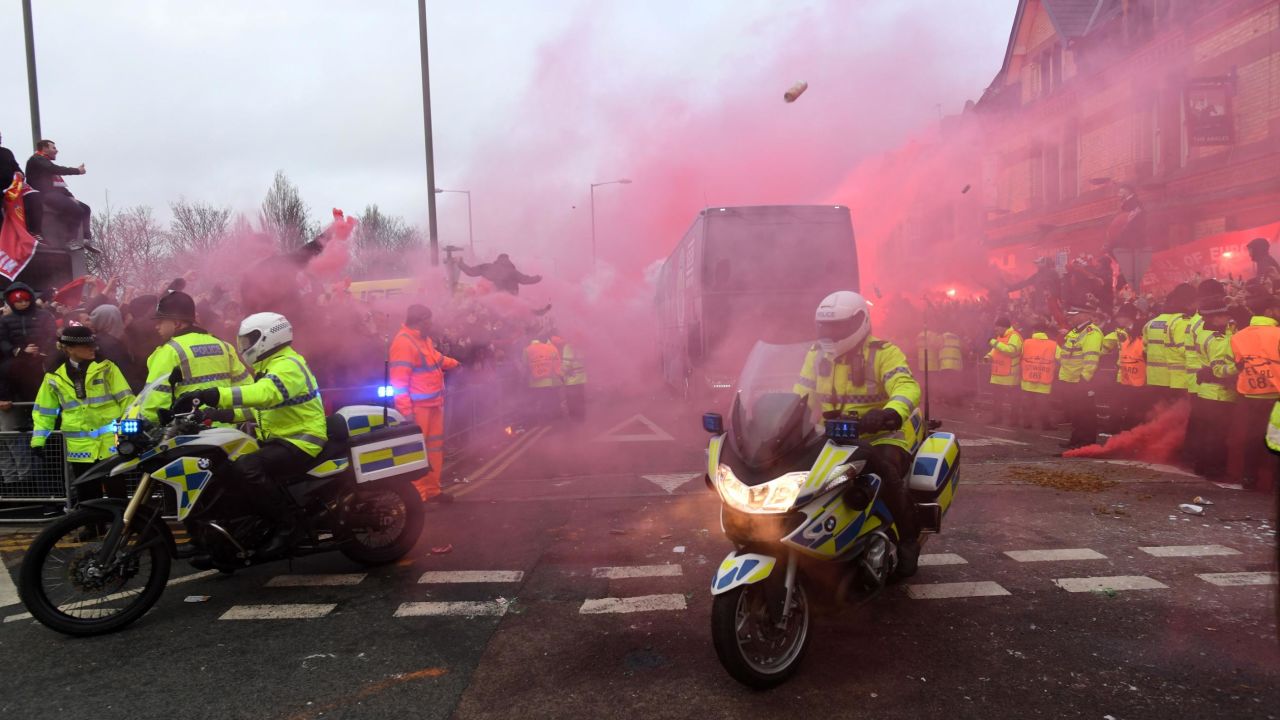 Manchester City's team bus is hit by projectiles thrown by Liverpool fans.