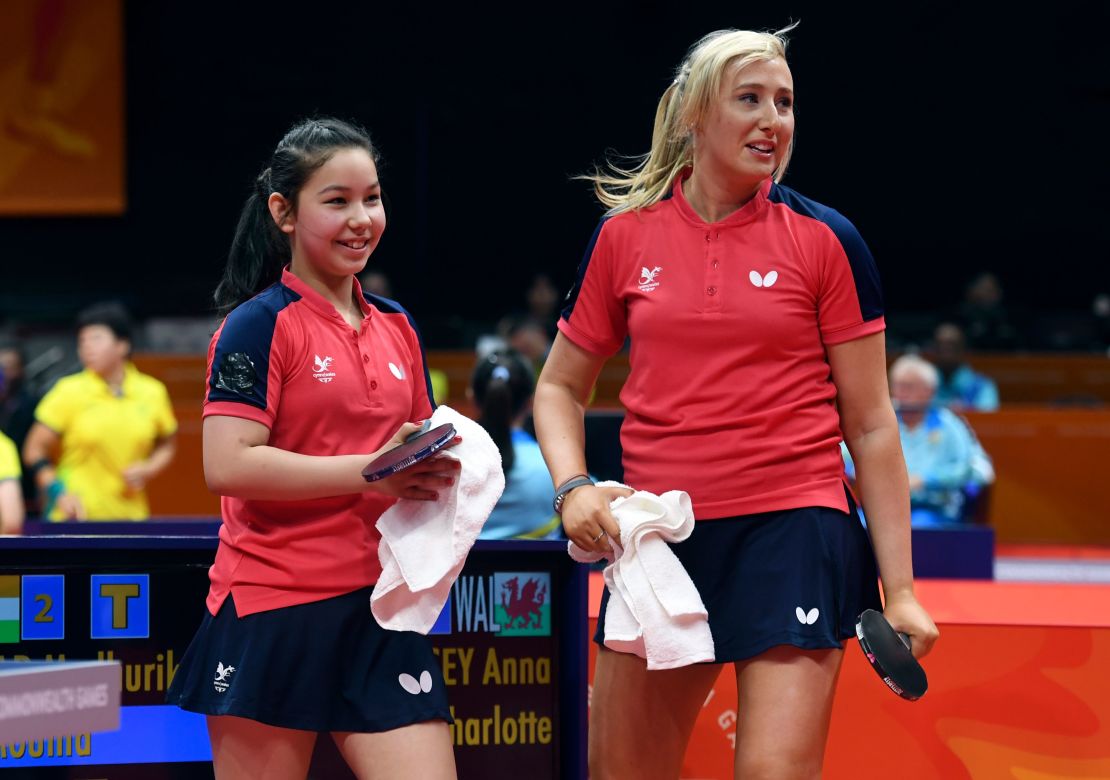 Eleven-year-old table tennis player Anna Hursey of Wales (L) celebrates with teammate Charlotte Carey (R) after winning their women's doubles match against India. 