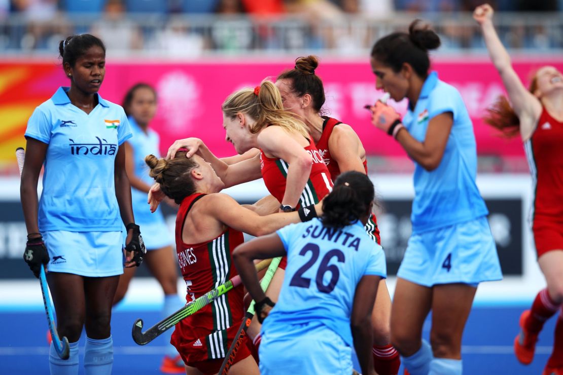 Natasha Marke-Jones of Wales celebrates with Phoebe Richards of Wales and Lisa Daley of Wales after scoring a goal during the Pool A Hockey match between Wales and India.