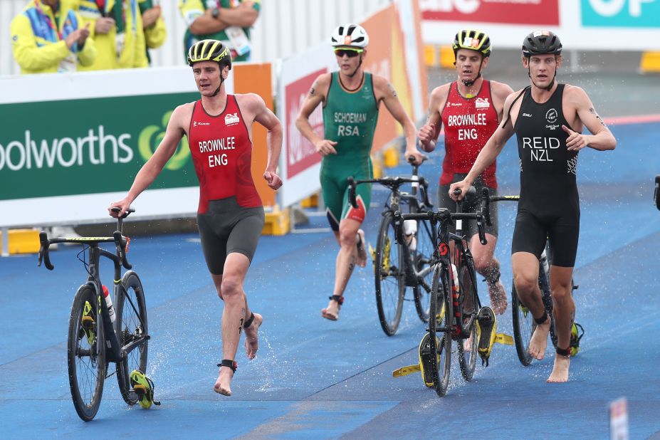 Alistair Brownlee (L) and Jonathan Brownlee of England compete with Tayler Reid of New Zealand in the mens triathlon.