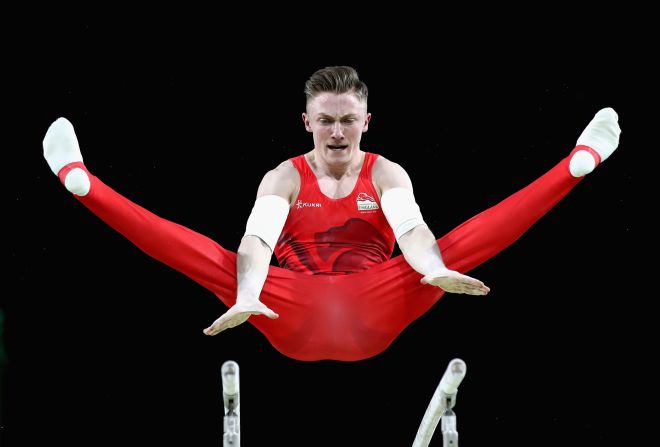 Nile Wilson of England competes on the parallel bars in the men's team final and individual qualification during the artistic gymnastics.