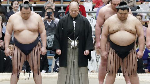 Japan Sumo Association Chairman Hakkaku, center, apologized after a referee ordered female medics to leave a sumo ring.