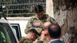 US Soldiers stand at attention during a visit of a US delegation to the YPG-held northern Syrian city of Manbij, where the US has a military presence, on March 22, 2018. / AFP PHOTO / Delil souleiman        (Photo credit should read DELIL SOULEIMAN/AFP/Getty Images)