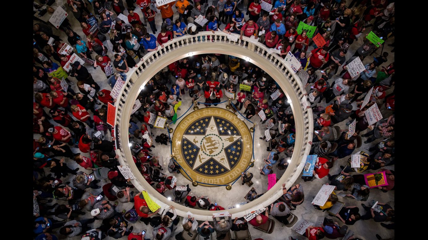 Protesters hold signs during a rally inside the Oklahoma State Capitol building on Tuesday, April 3. <a href="https://www.cnn.com/2018/04/03/us/oklahoma-teachers-walkout/index.html" target="_blank">Hundreds of teachers</a> have been filling the Capitol this week, demanding an additional $150 million in school funding and increased raises for themselves and support staff.