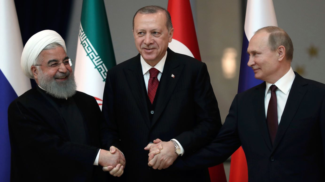 From left, Iranian President Hassan Rouhani, Turkish President Recep Tayyip Erdogan and Russian President Vladimir Putin lock hands for a photo in Ankara, Turkey, on Wednesday, April 4. The leaders <a href="https://www.cnn.com/2018/04/04/middleeast/syria-iran-turkey-russia-us-summit-intl/index.html" target="_blank">ended a summit</a> Wednesday with a commitment to achieving a "lasting ceasefire" in Syria, even as the future role of US forces in the country remains in doubt. <a href="http://www.cnn.com/2015/05/22/world/gallery/syria-civil-war-pictures/index.html" target="_blank">Syria's civil war, in pictures</a>