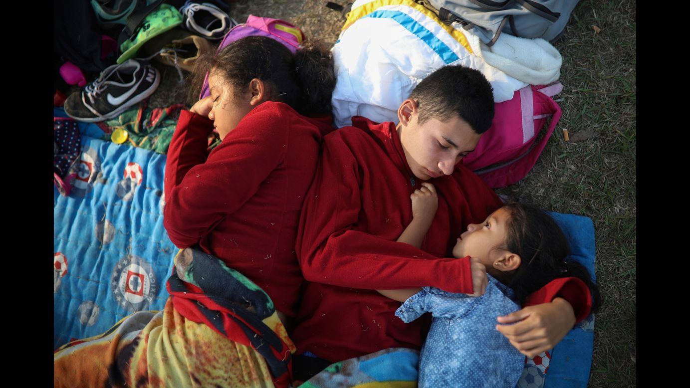 The Zelaya siblings -- from left, Daniela, Anderson and Nayeli -- huddle together on a soccer field in Matias Romero, Mexico, on Wednesday, April 4. They were <a href="https://www.cnn.com/2018/04/05/americas/caravan-mexico-migrants/index.html" target="_blank">traveling with other Central American migrants</a> in the Stations of the Cross caravan. Their father, Elmer, said the family is awaiting temporary transit visas that would allow them to continue to the US border, where they hope to request asylum and join relatives in New York.