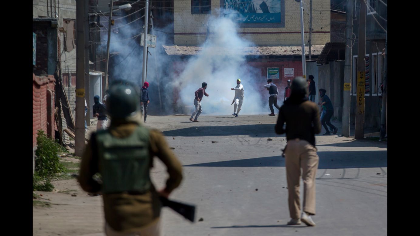Kashmiri civilians clash with Indian paramilitary soldiers during a protest in Srinagar, India, on Sunday, April 1. They were protesting <a href="https://www.cnn.com/2018/04/03/asia/violence-kashmir-isis-intl/index.html" target="_blank">the military's recent raids</a> against militant groups in Indian-administered Kashmir.