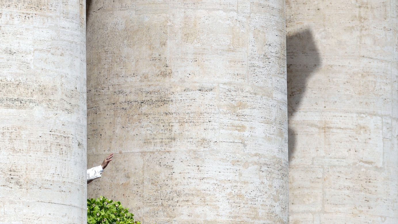 Pope Francis waves to faithful at the Vatican after delivering his Urbi et Orbi message on Sunday, April 1.