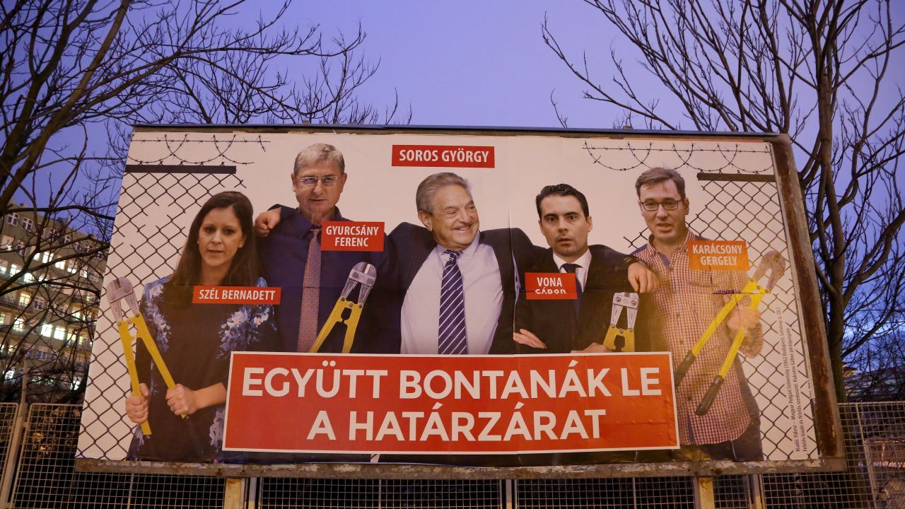 A Fidesz billboard features Soros among opposition figures and says, "They would dismantle the border fence together."