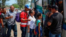 Central American migrants traveling with the annual "Stations of the Cross" caravan board a bus that will take them to Mexico City, at the sports club where they had been camping out in Matias Romero, Oaxaca State, Mexico, Thursday, April 5, 2018. Migrants in the caravan that drew criticism from U.S. President Donald Trump began packing up their meager possessions and boarding buses to the Mexican capital and the nearby city of Puebla. (AP Photo/Felix Marquez)