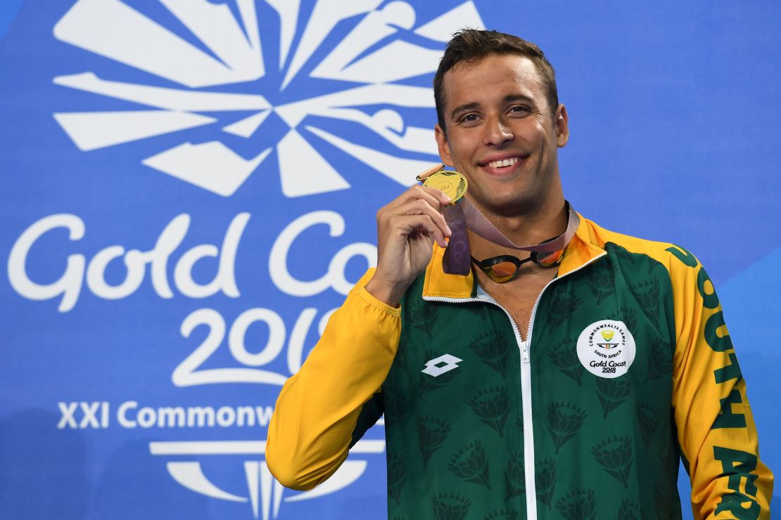 South Africa 's Chad Le Clos poses with his gold medal after the swimming men's 50m butterfly final.