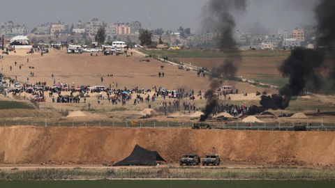 Israeli soldiers are seen as Palestinians protest at the Israel-Gaza border on Friday.