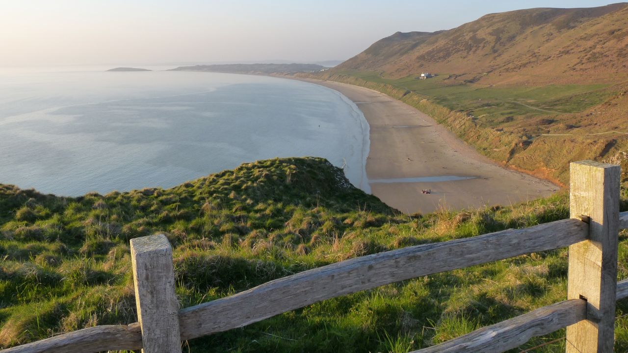 <strong>Rhossili Bay, Gower Peninsula: </strong>Lauded as one of the top stretches of sand around, Rhossili Beach is adored by surfers and swimmers, while walkers admire its  clifftop paths, which takes in views of tidal island Worm's Head.