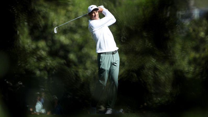 Ross Fisher plays his second shot on the fifth hole Friday.