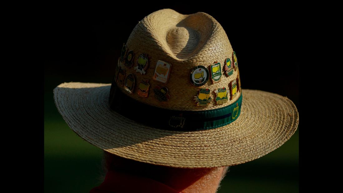 Masters pins adorn a spectator's hat on Friday.